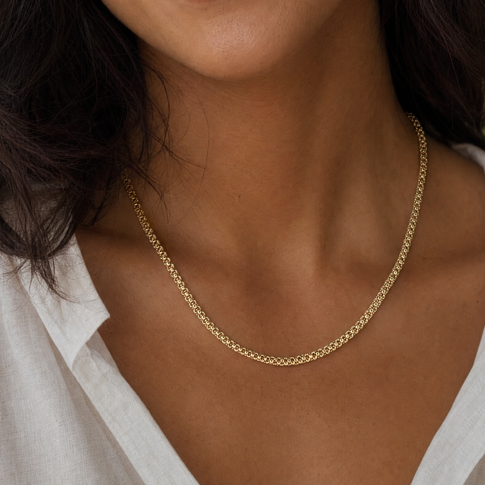 yellow gold beaded chain necklace on women