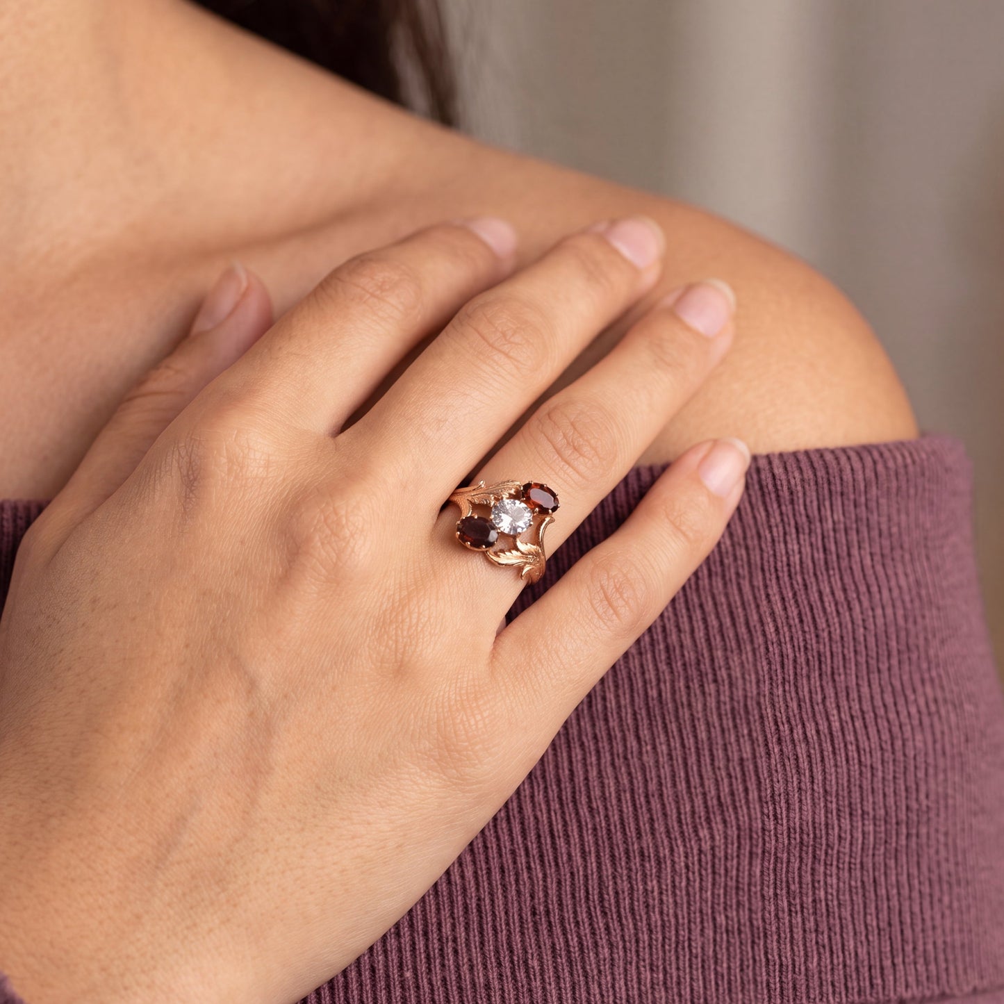 yellow gold ring and gemstones on finger 